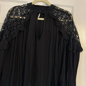 Free People black long sleeve top with crocheted decor at shoulders